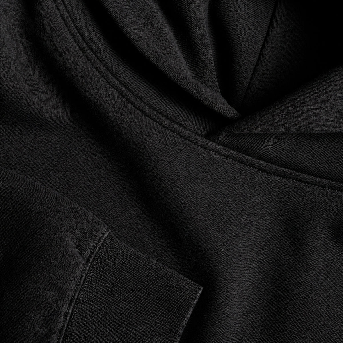 Close-up of black  fabric showing seam and stitching