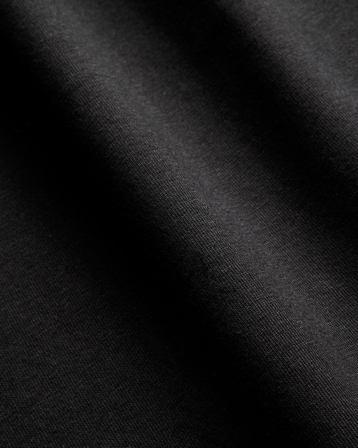Close-up of heavyweight black cotton T-shirt fabric texture