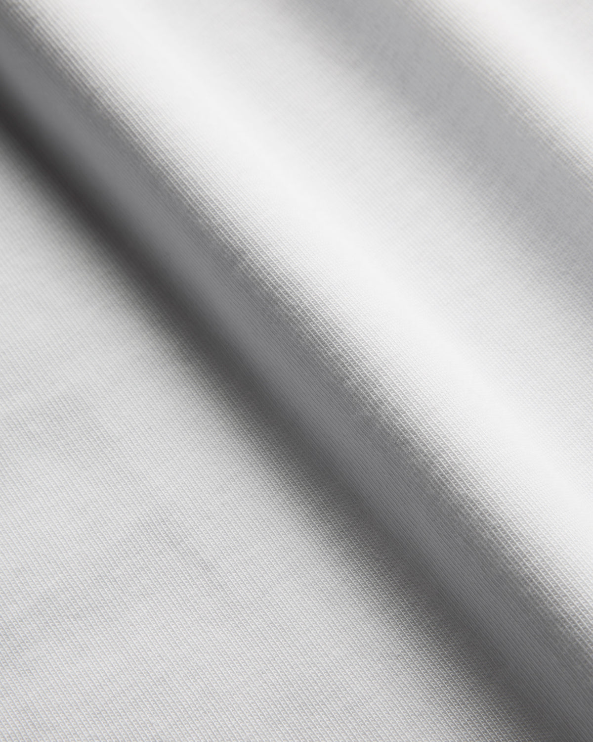 Close-up of heavyweight white cotton T-shirt fabric texture
