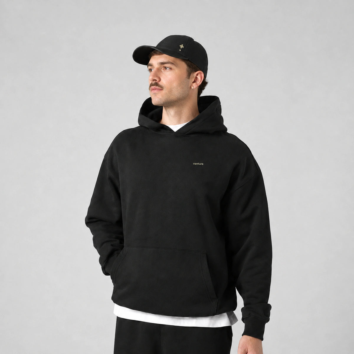 Vanture Beginning Hoodie in black worn by male model, front view