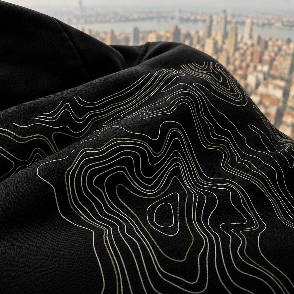 Close-up of the black Vanture Beginning Hoodie showing the topographic back print