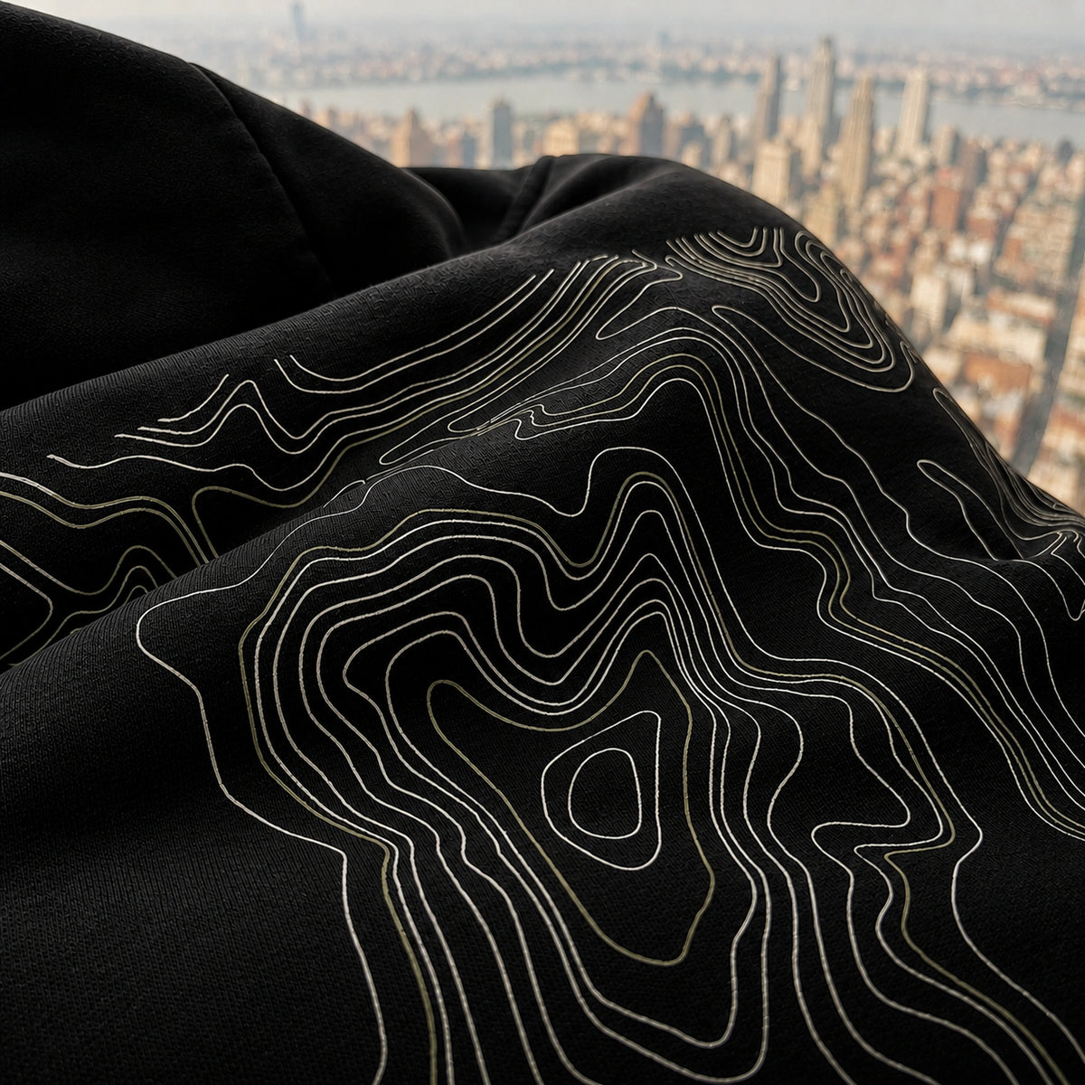Close-up of the black Vanture Beginning Hoodie showing the topographic back print