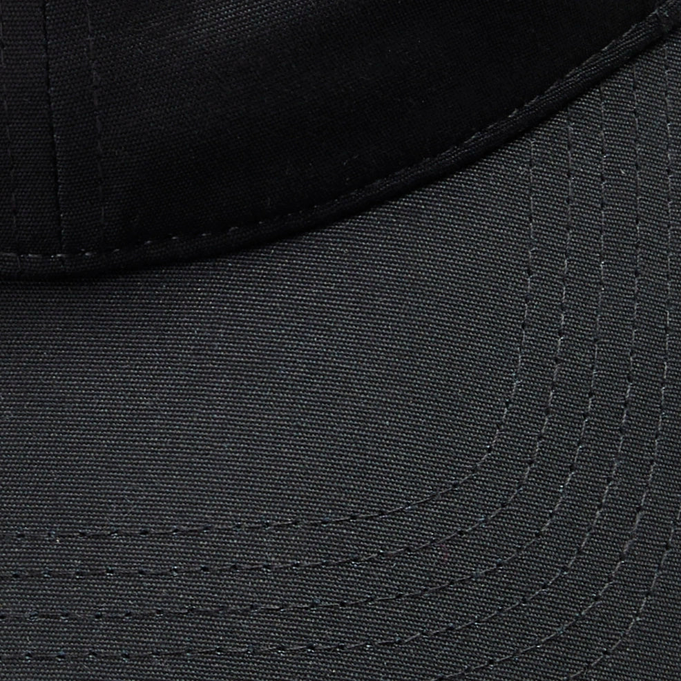 Close-up of black Vanture Icon Cap showing tonal stitching and fabric texture on the brim