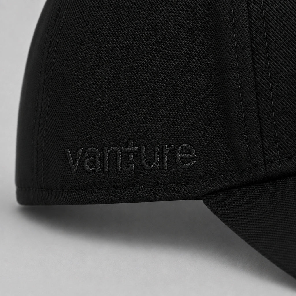 Close-up of black Vanture Icon Cap showing tonal Vanture embroidery and fabric texture
