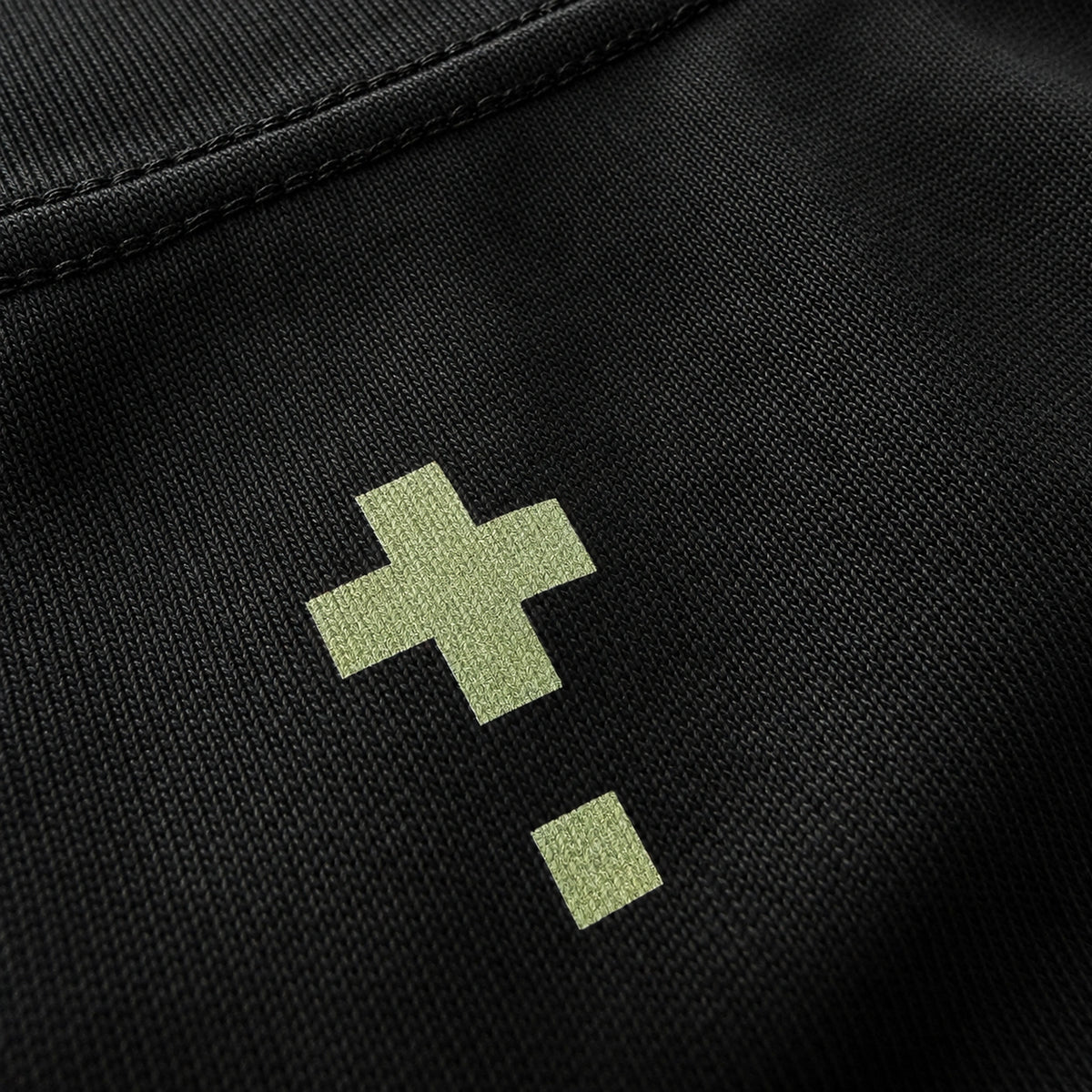 Close-up of the Vanture Icon T-shirt back graphic showing off sand green vanture icons on black heavyweight cotton fabric