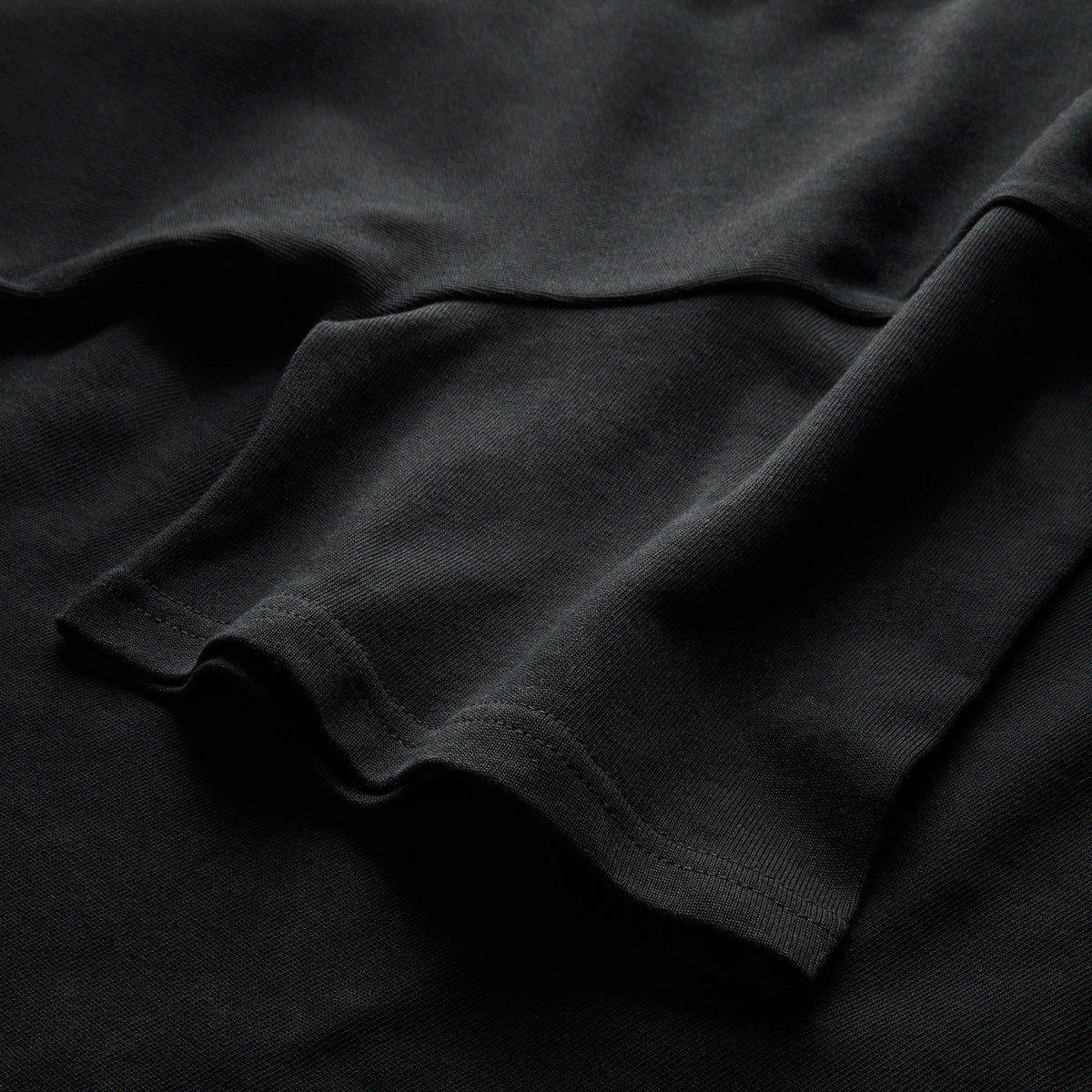 Close-up of black Vanture heavyweight cotton T-shirt showing fabric and stitching detail