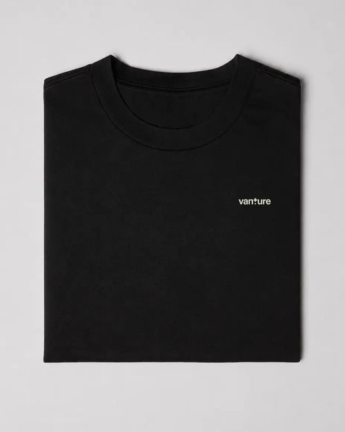 Folded black Vanture heavyweight T-shirt showing the small Vanture chest print