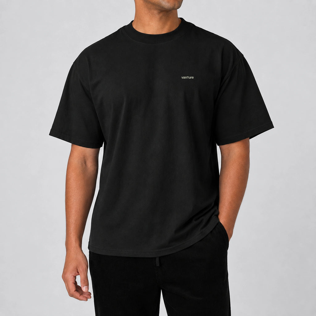 Model wearing the black Vanture T2 Era T-shirt with small chest logo