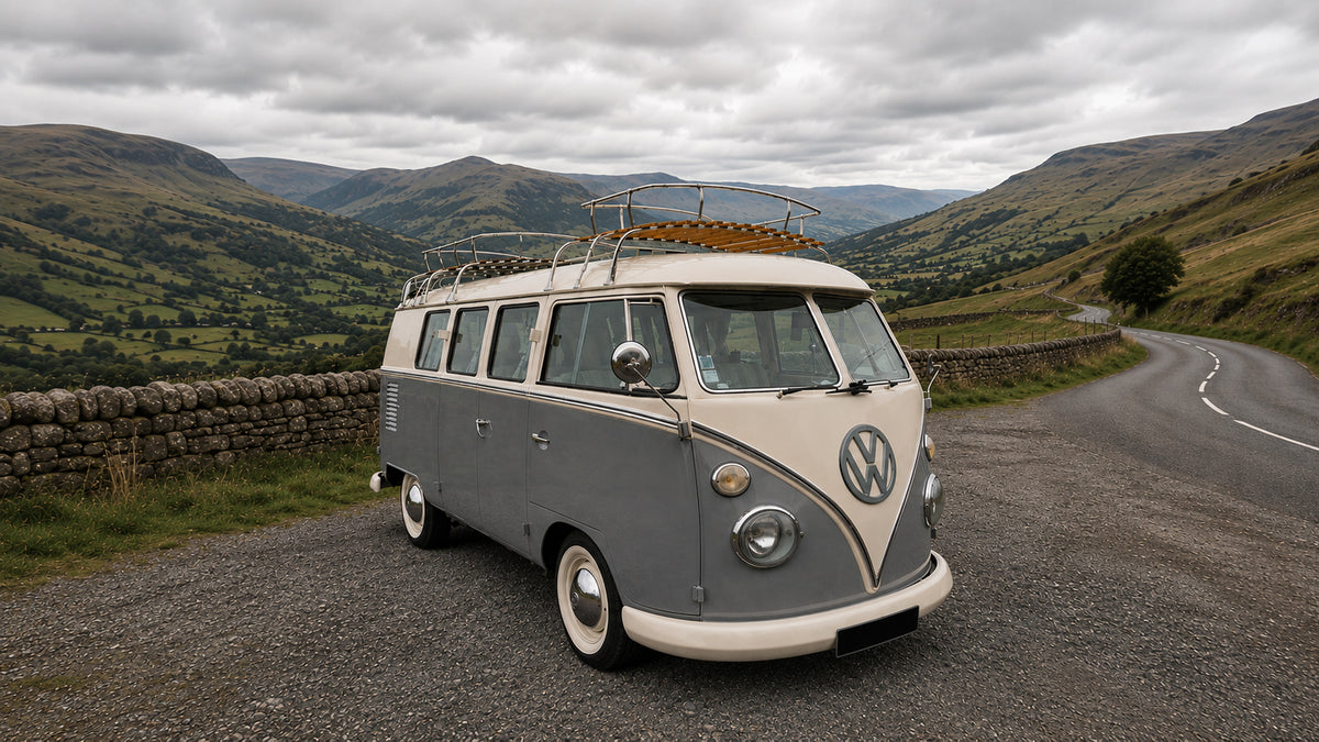 Mouse Grey and cream VW T1 campervan parked in a countryside layby with rolling hills and stone walls.
